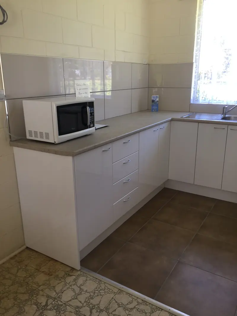 Kitchenette with microwave, benchtop and sink in a kitchen unit
