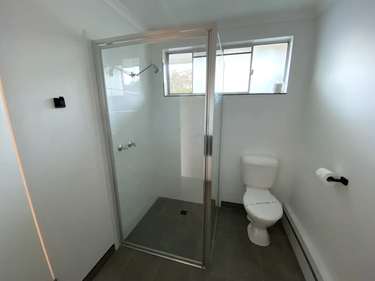 New shower with a glass screen and tiled floor